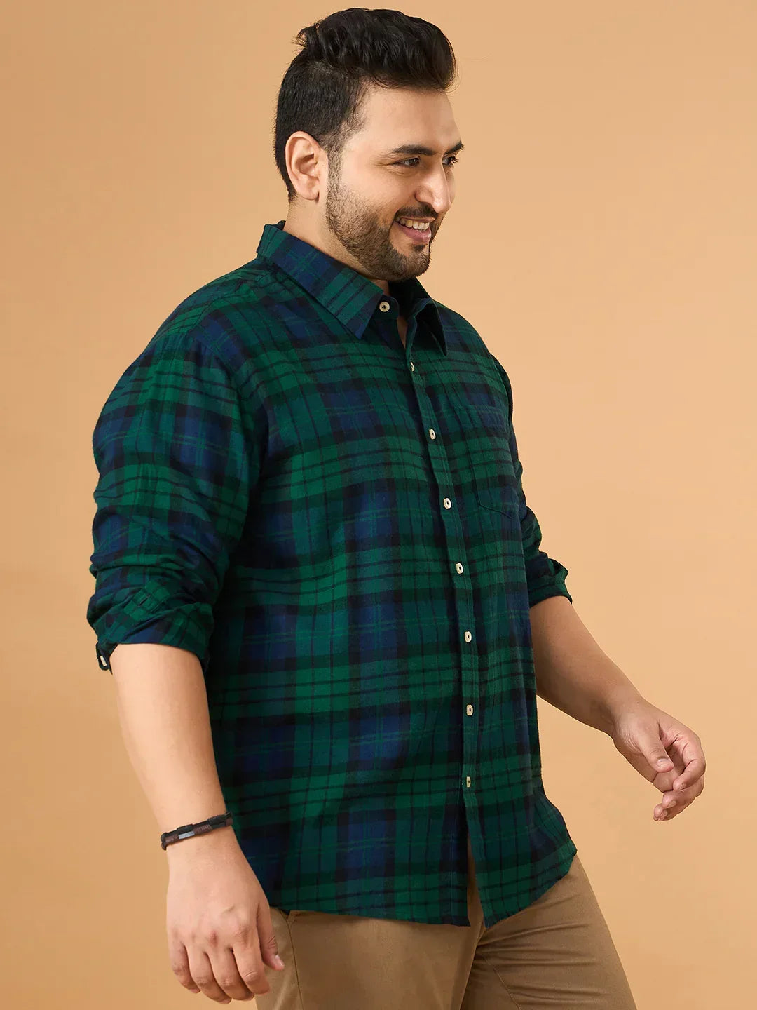 Plus size man wearing a green and navy checked casual shirt with rolled sleeves