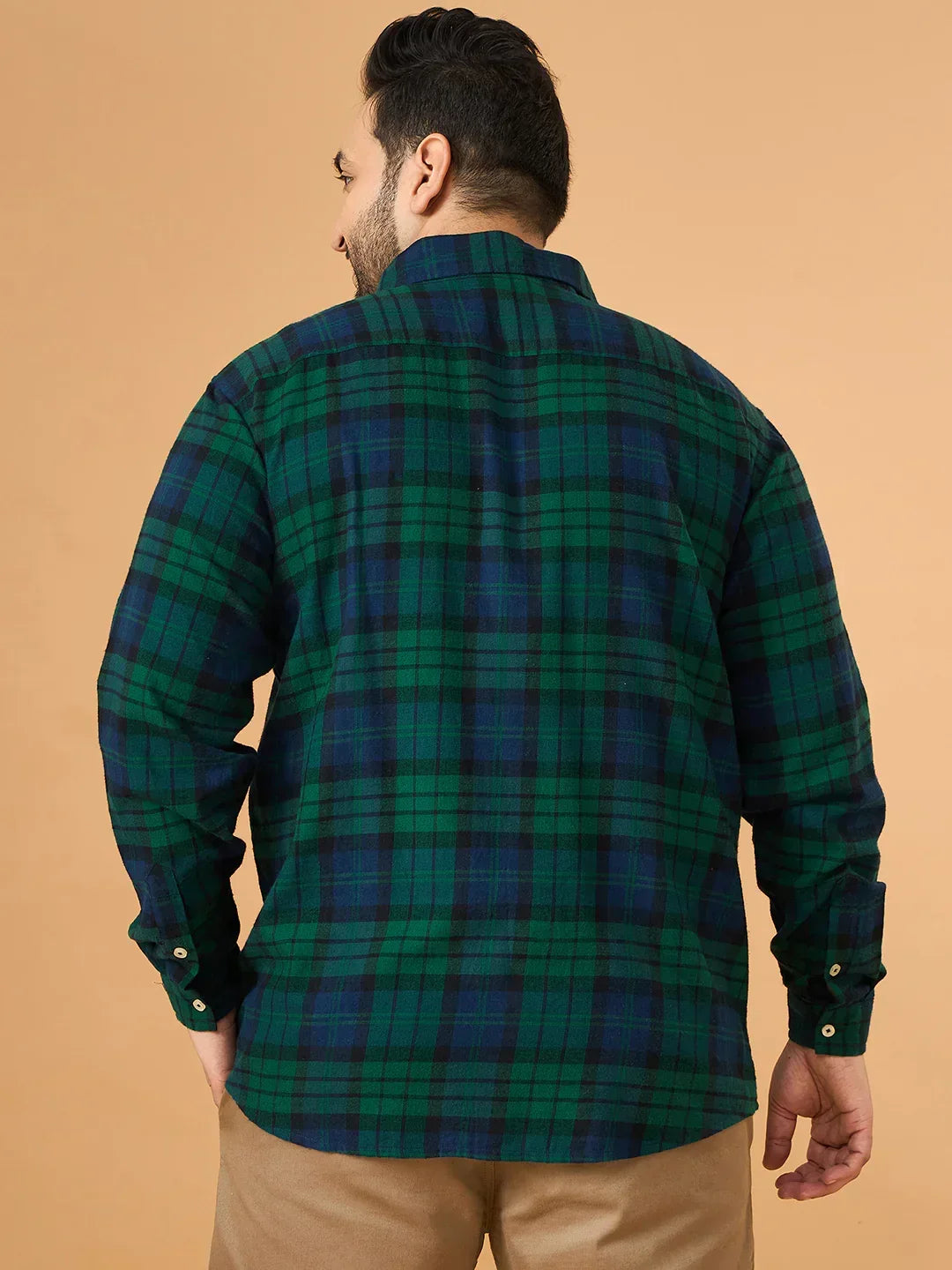 Man wearing green and blue plaid plus size shirt with long sleeves, viewed from the back