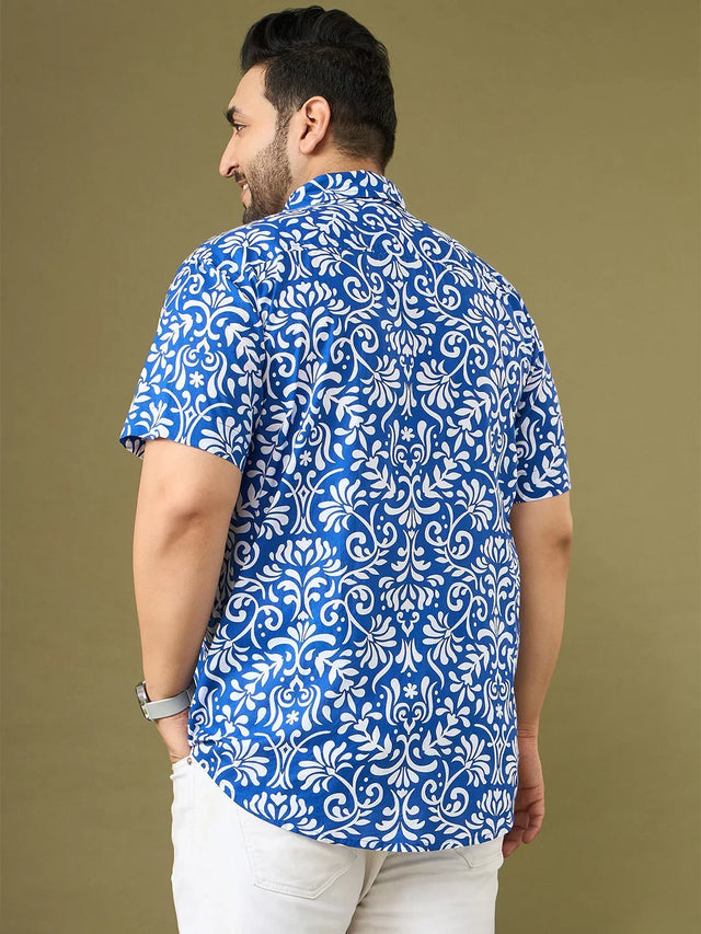 Plus size man in blue and white floral print short sleeve shirt, beige background