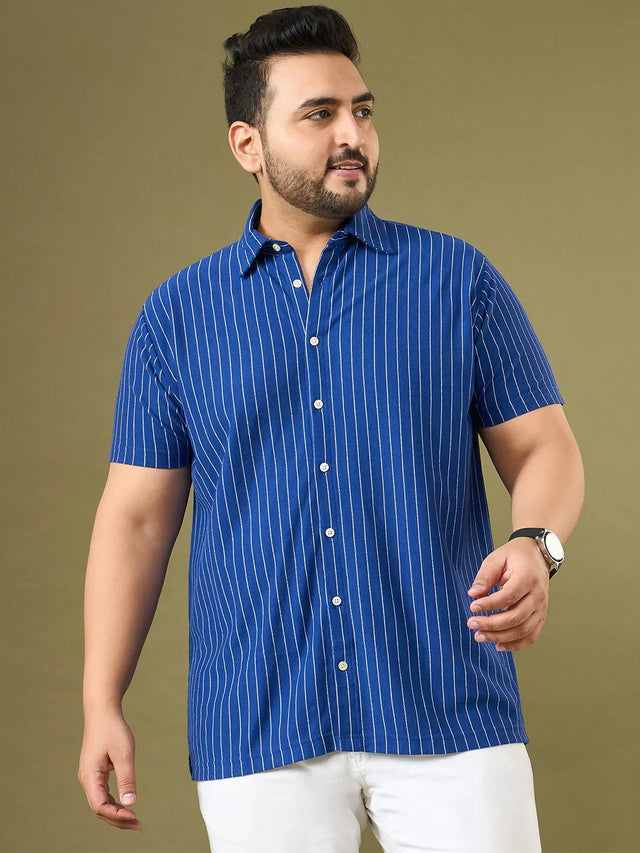 Plus size man wearing blue short sleeve vertical striped shirt and white pants