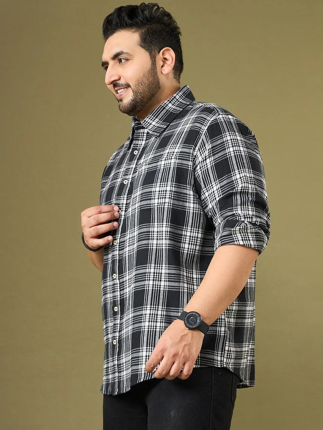 Plus size man wearing black and white plaid shirt and black jeans, casual fashion