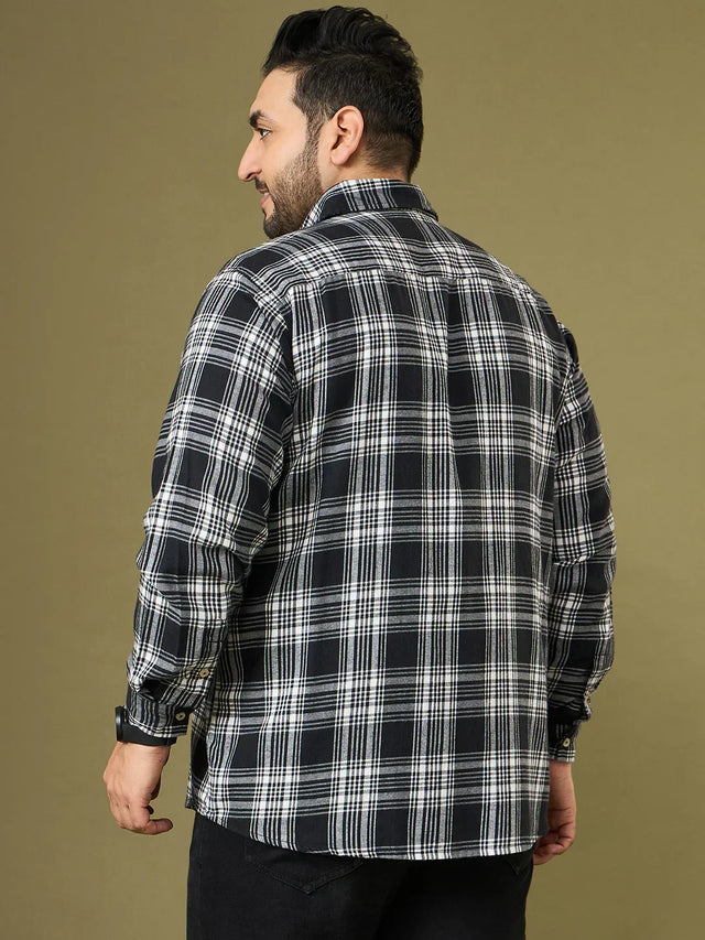 Plus size man wearing black and white checkered shirt, back view, casual style