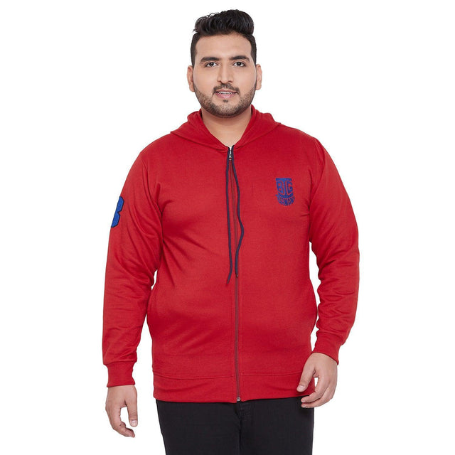 Plus size man wearing red zip-up hoodie with blue emblem, front view on white background
