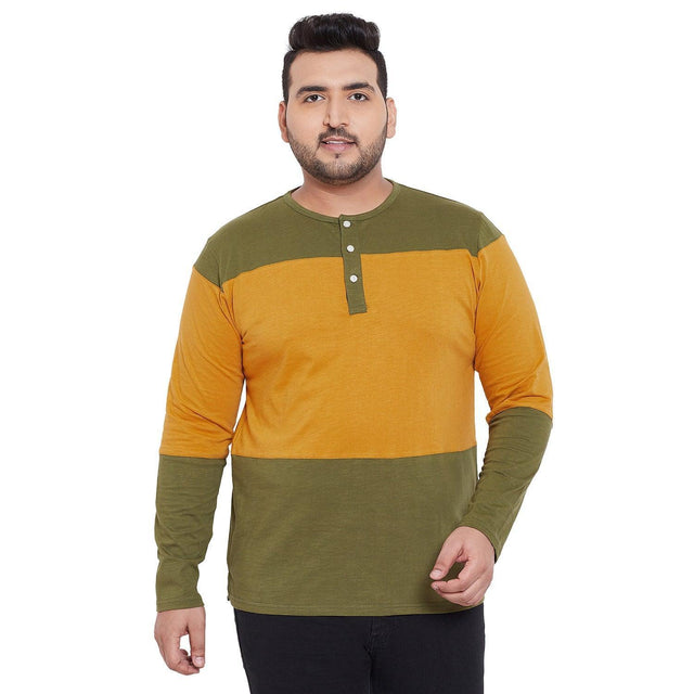 Plus size man wearing olive green and mustard colorblock long sleeve Henley t-shirt