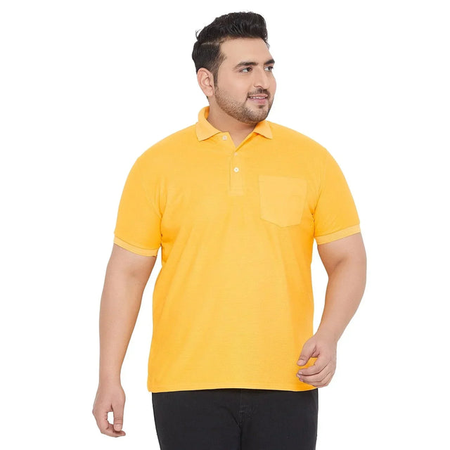 Plus size man wearing yellow polo t-shirt with chest pocket and black pants on white background