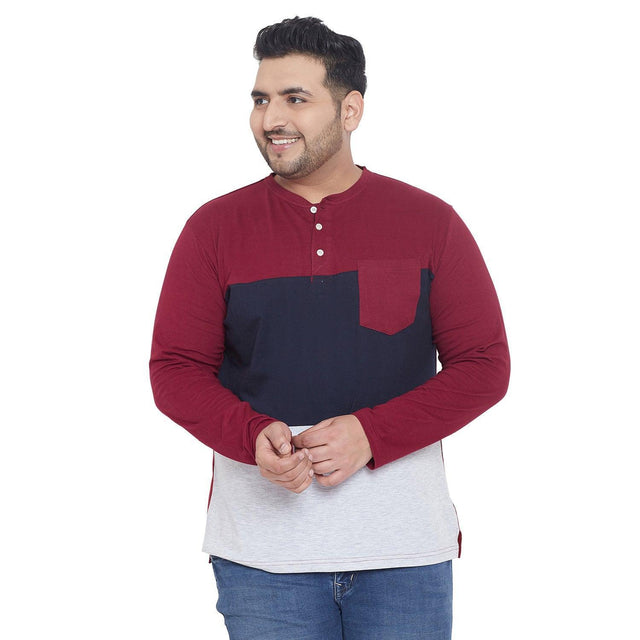 Plus size man wearing colorblock maroon, navy, and grey Henley t-shirt with pocket