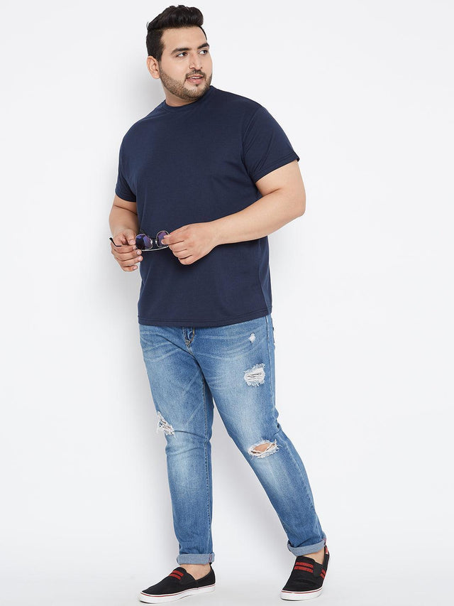 Plus size man in navy t-shirt and ripped blue jeans, casual fashion for men