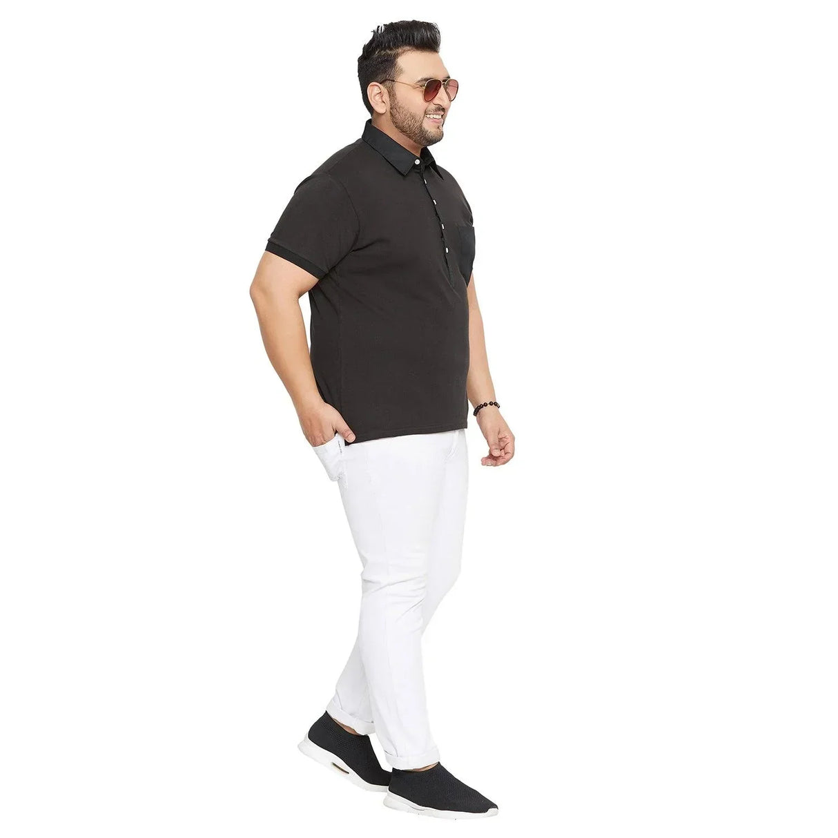 Plus size man wearing black polo shirt and white pants, side view on white background