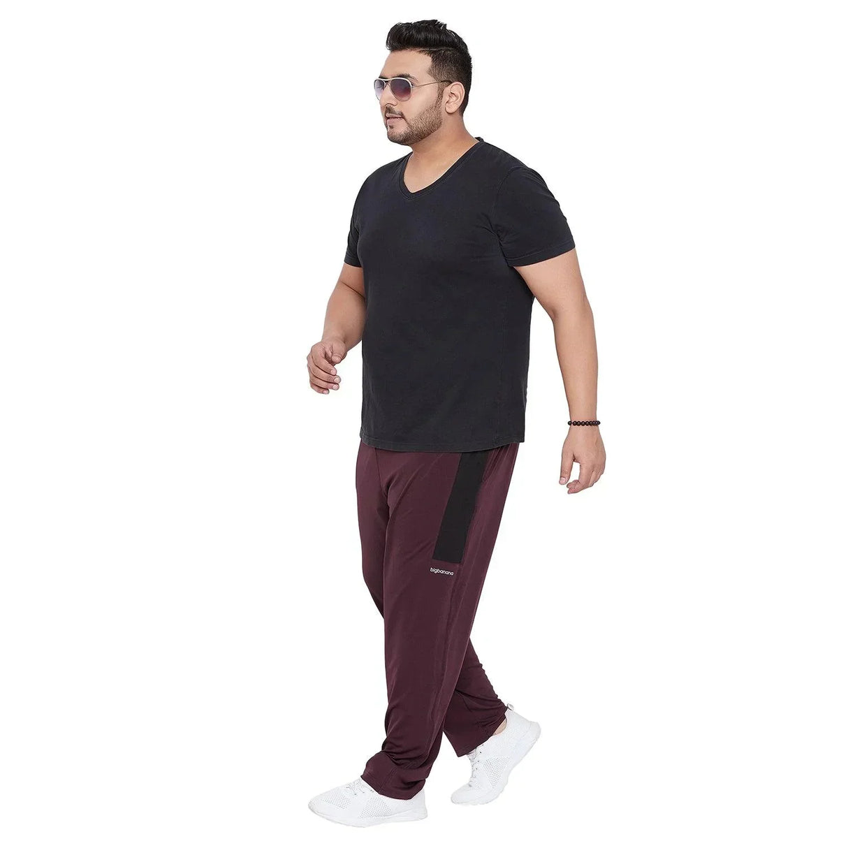 Plus size man in black V-neck t-shirt and maroon joggers with white sneakers