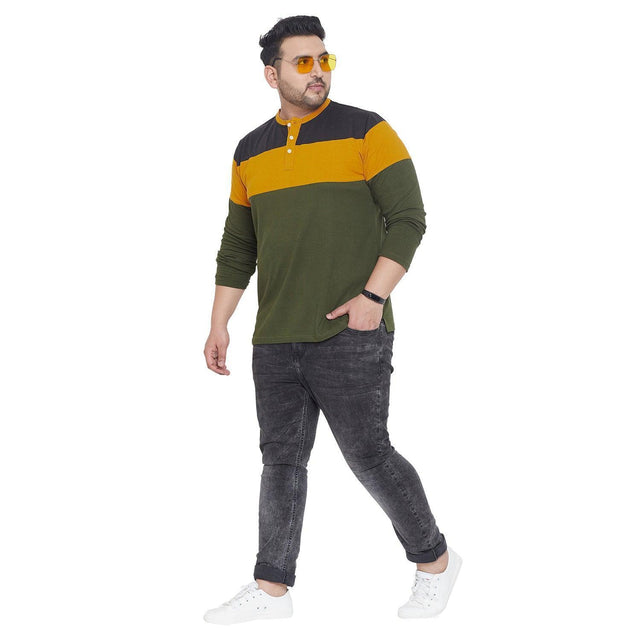 Plus size man modeling colorblock henley t-shirt with jeans and white sneakers