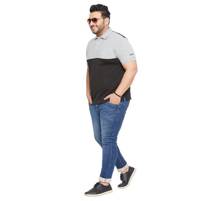 Plus size man in grey and black polo t-shirt, blue jeans, and sunglasses, casual style