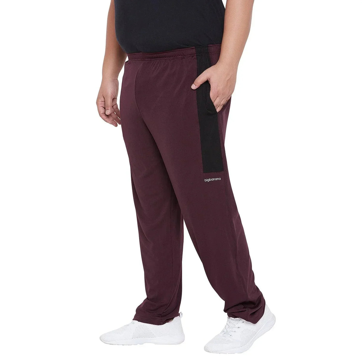 Men's plus size maroon track pants with black side stripe, elastic waist, white sneakers