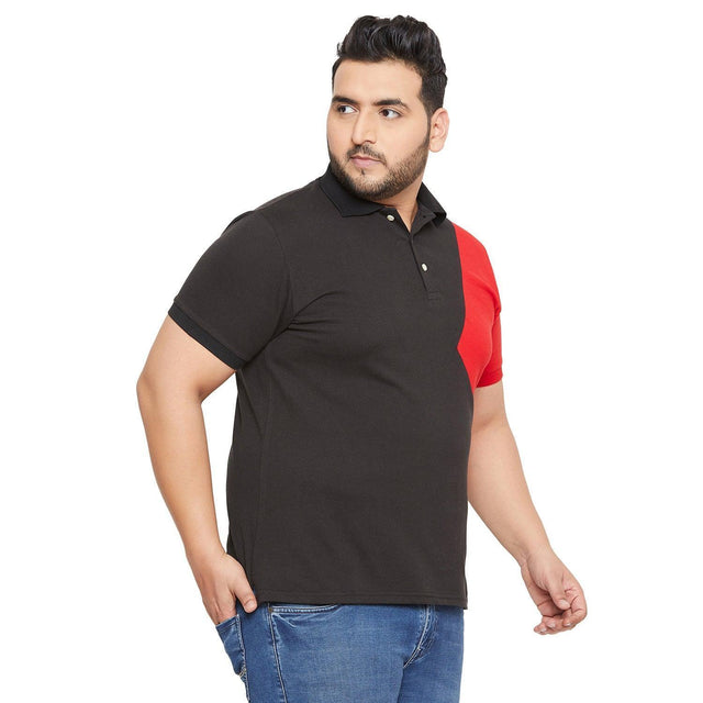 Plus size man in black and red colorblock polo t-shirt and blue jeans on white background.
