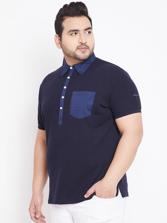 Plus size man wearing a navy blue short-sleeve polo shirt with contrast collar and pocket