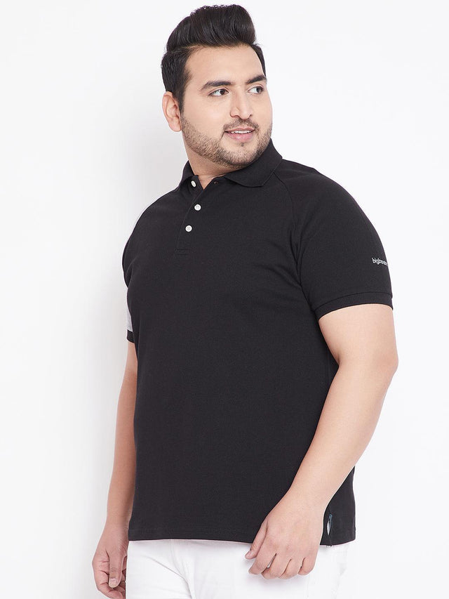 Plus size man wearing black polo shirt with white pants, front view, casual men’s fashion