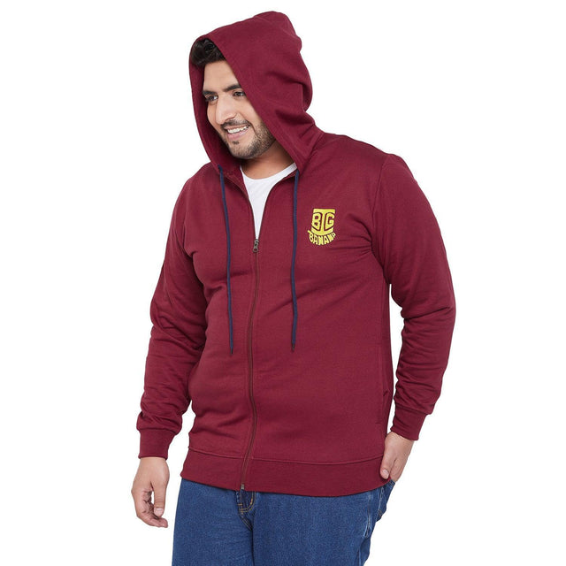 Plus size man wearing maroon zip-up hoodie with hood up and logo, casual fashion