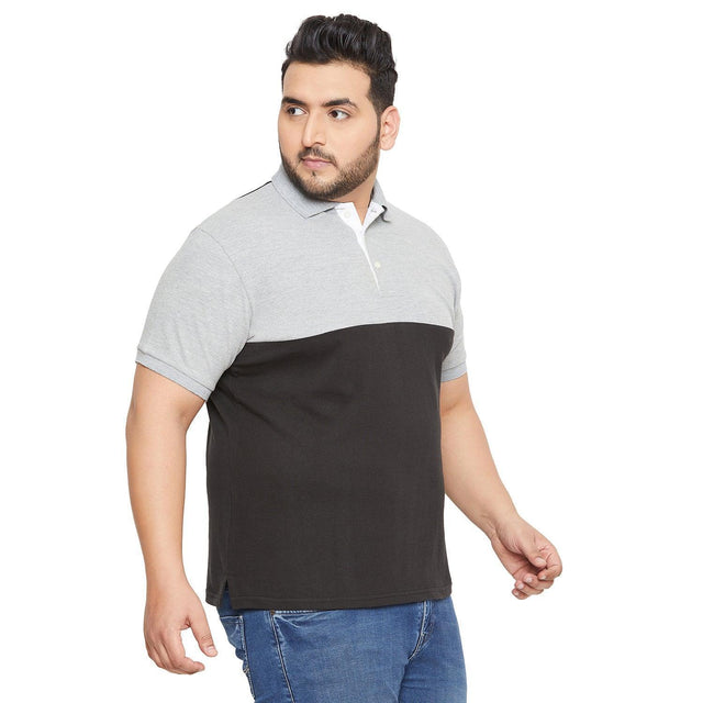 Plus size man wearing colorblock grey and black polo shirt with blue jeans