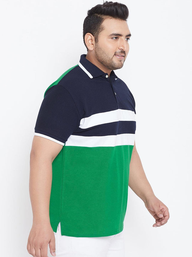 Plus size man in navy, white, and green color-block polo shirt with white pants
