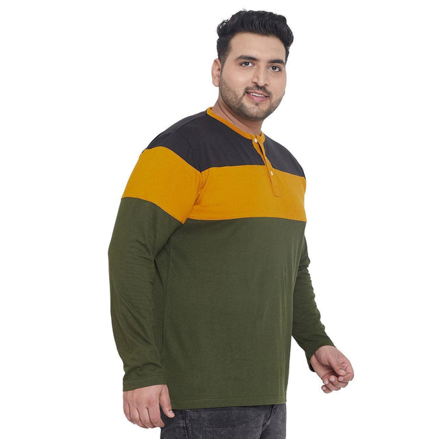 Plus size man wearing a colorblock long sleeve t-shirt in black, mustard, and olive green