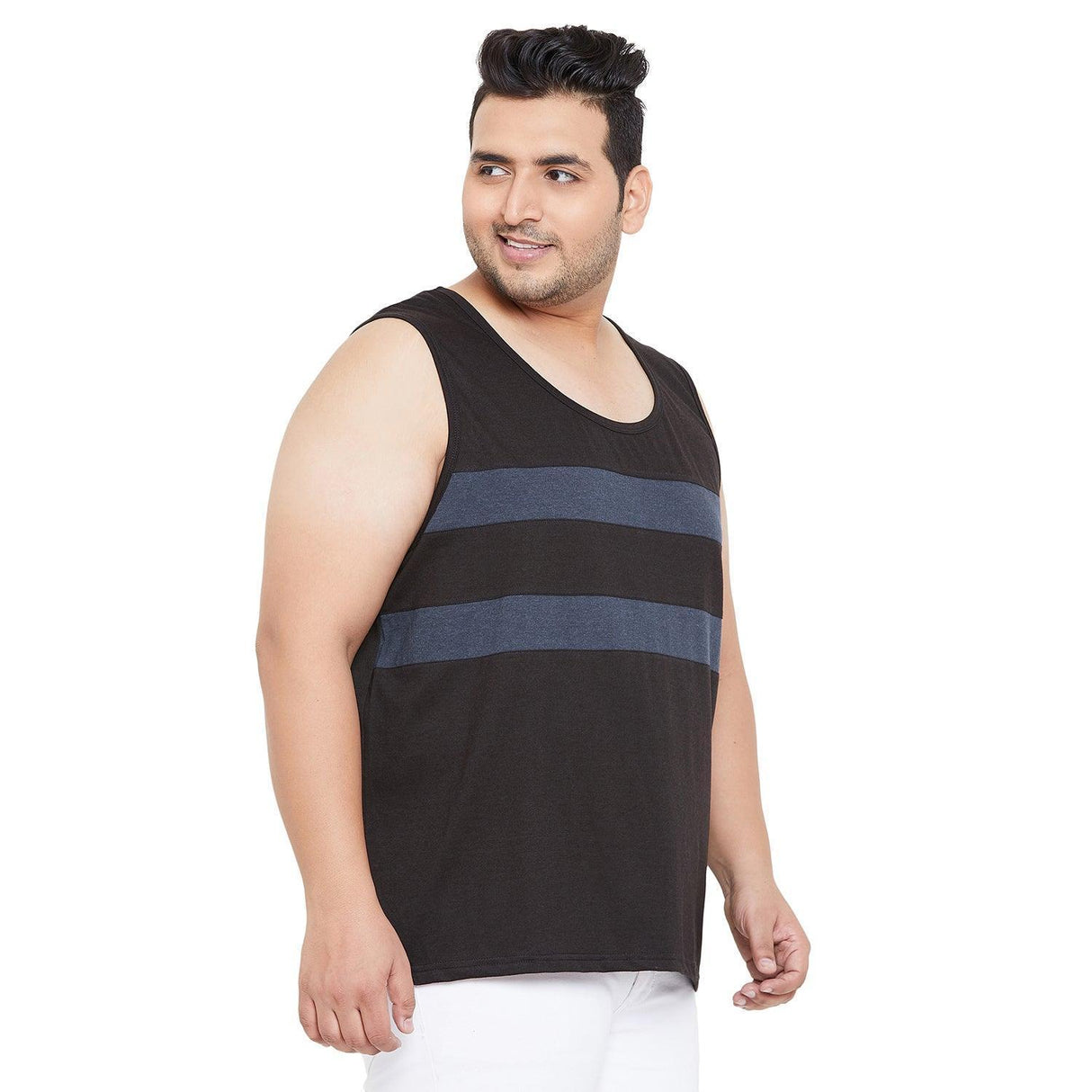 Plus size man in black sleeveless t-shirt with blue stripes, white pants, studio background