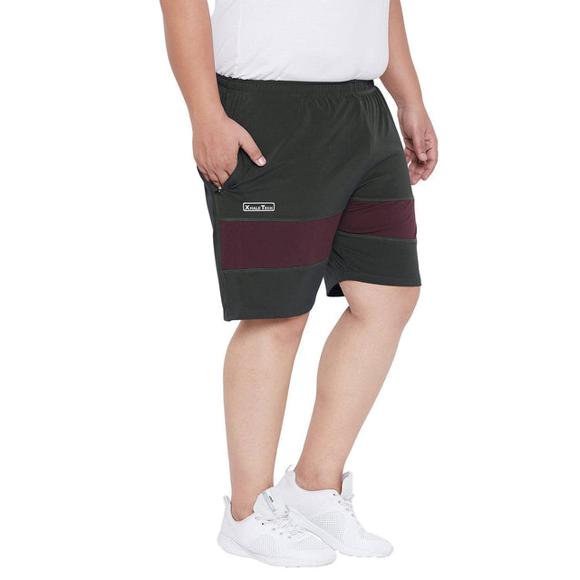 Men's plus size black and maroon shorts with elastic waistband, modeled with white sneakers.