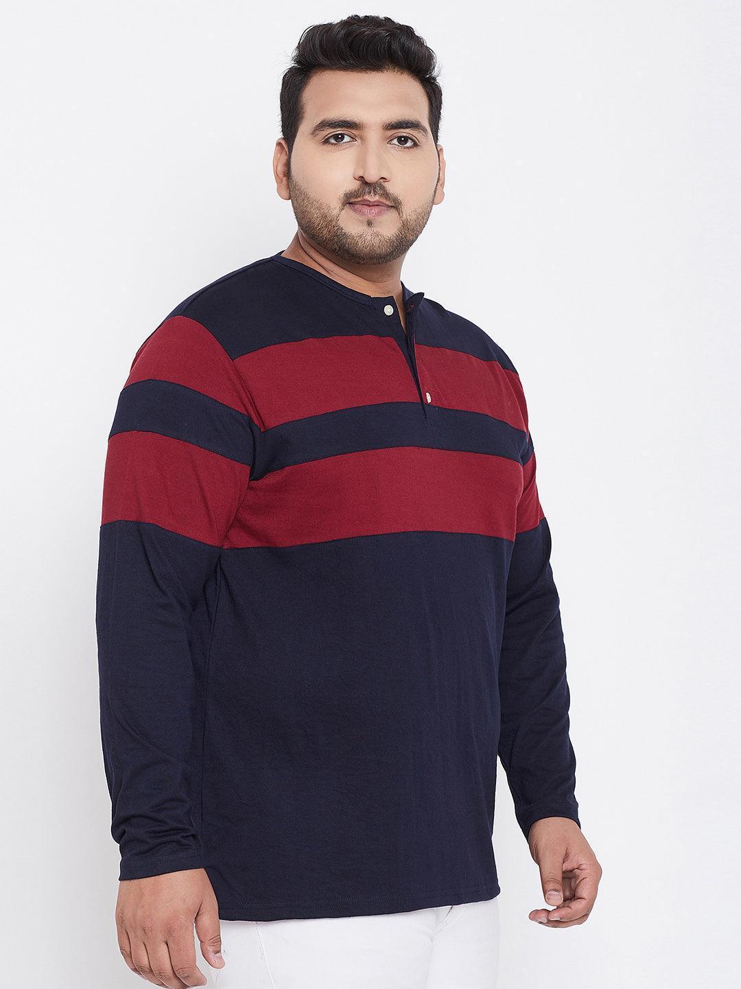 Plus size man wearing navy and maroon striped long sleeve t-shirt, white background