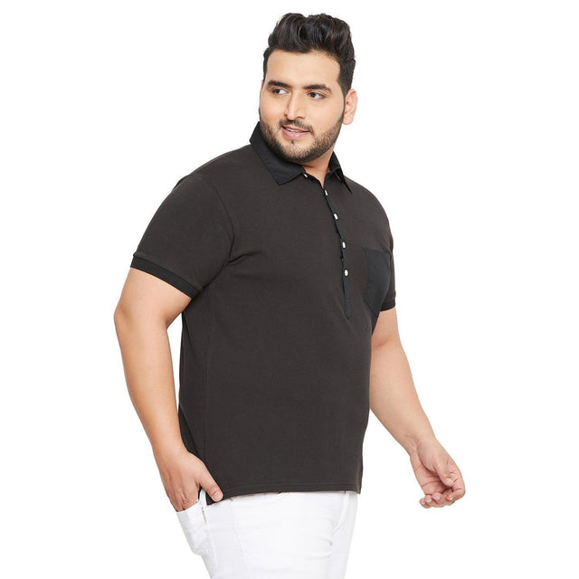 Plus size man in black short sleeve polo shirt and white pants on white background