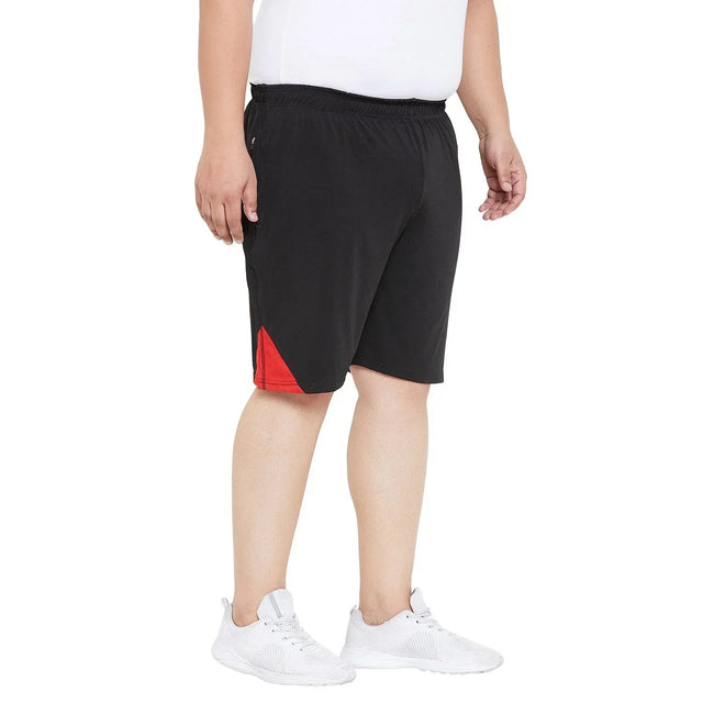 Men's plus size black shorts with red detail, elastic waistband, modeled on a white background
