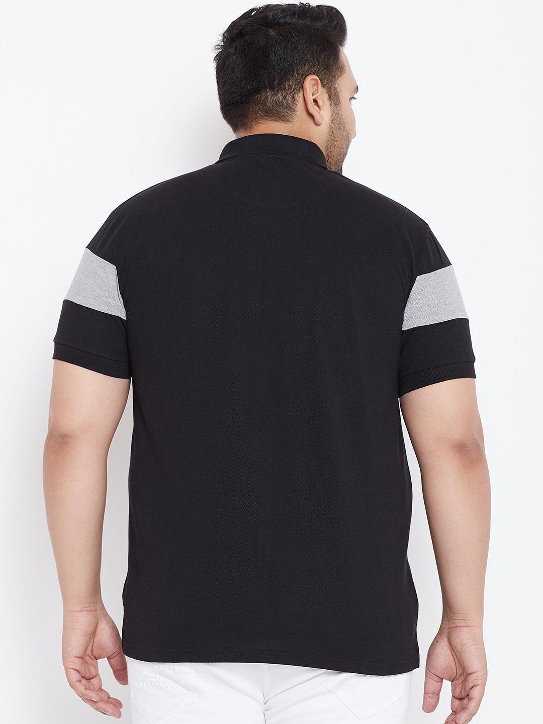 Back view of man in black plus size polo shirt with grey sleeve stripes, white pants