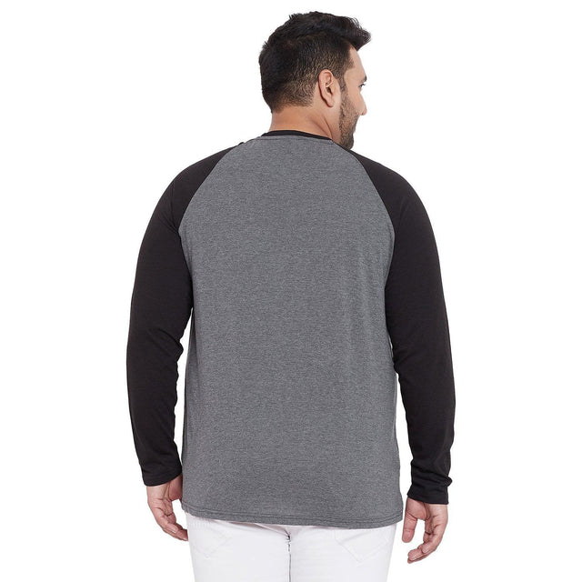 Plus size man wearing grey and black long sleeve raglan t-shirt, back view