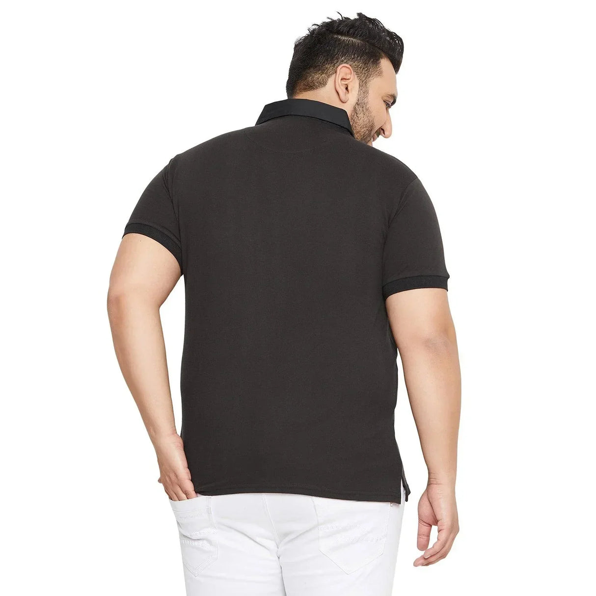 Back view of a plus size man in a black polo shirt and white jeans on white background