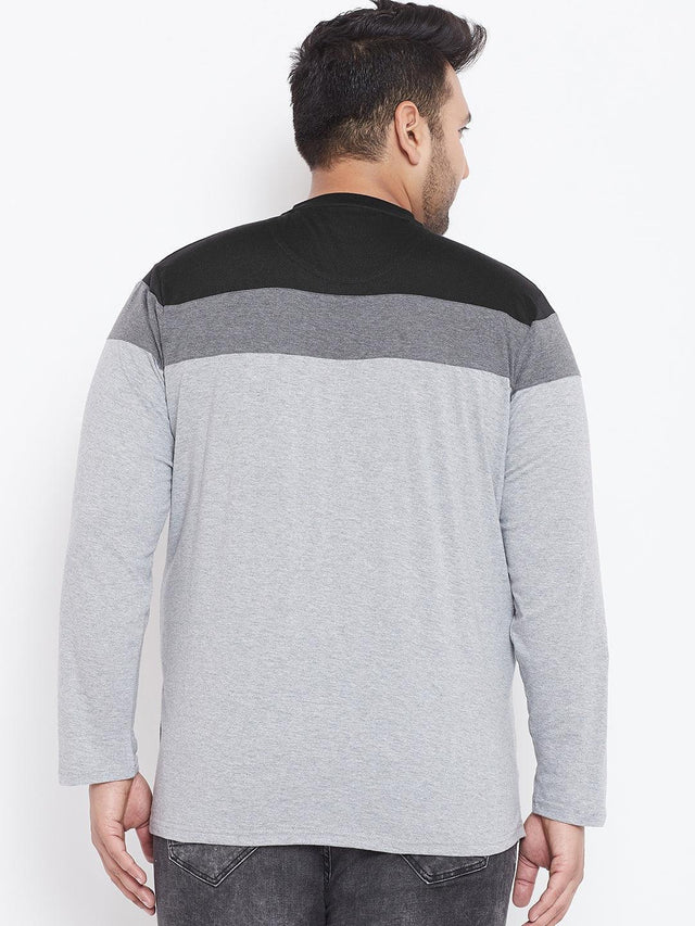 Back view of a man wearing a colorblock long sleeve plus size t-shirt in grey and black.
