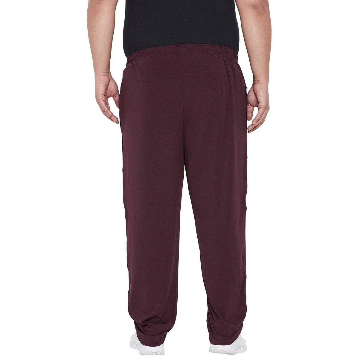 Back view of a man wearing maroon plus size joggers and white sneakers