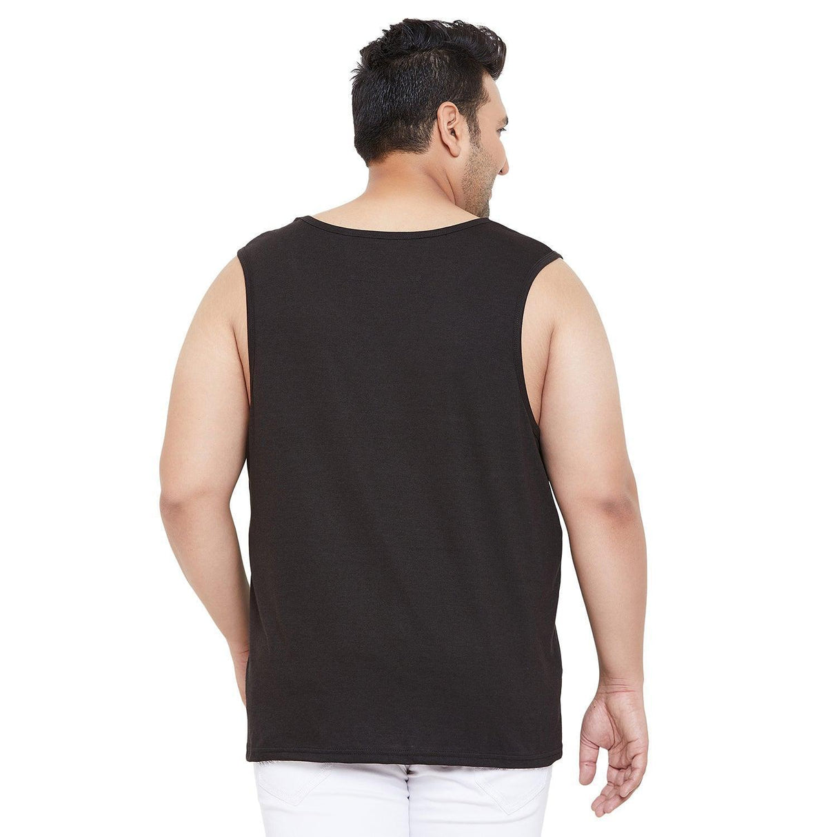 Back view of a man wearing a black plus size sleeveless t-shirt and white pants