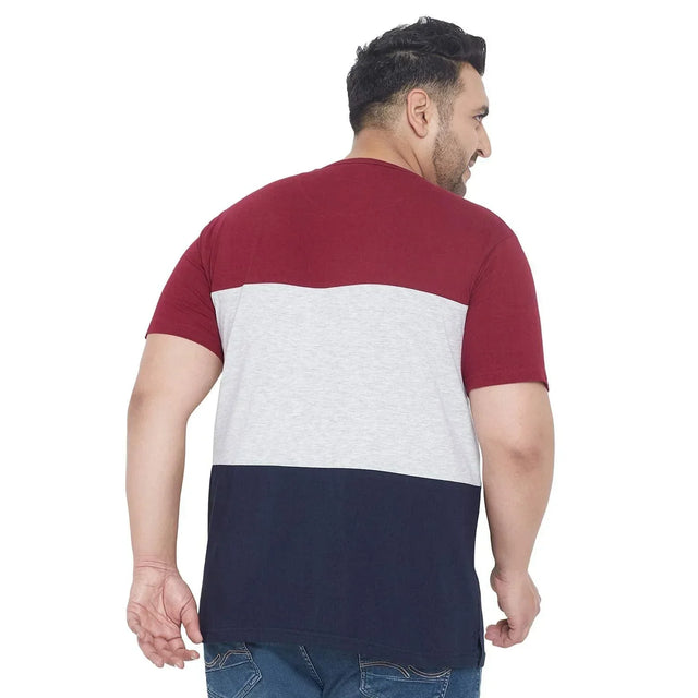 Plus size man in a colorblock t-shirt with burgundy, grey, and navy stripes, back view