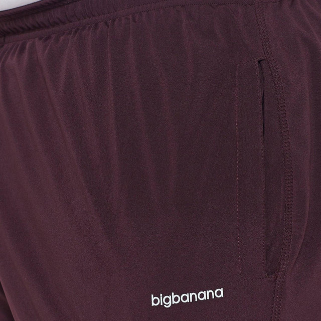 Maroon men's plus size joggers with pocket and elastic waistband, close up view