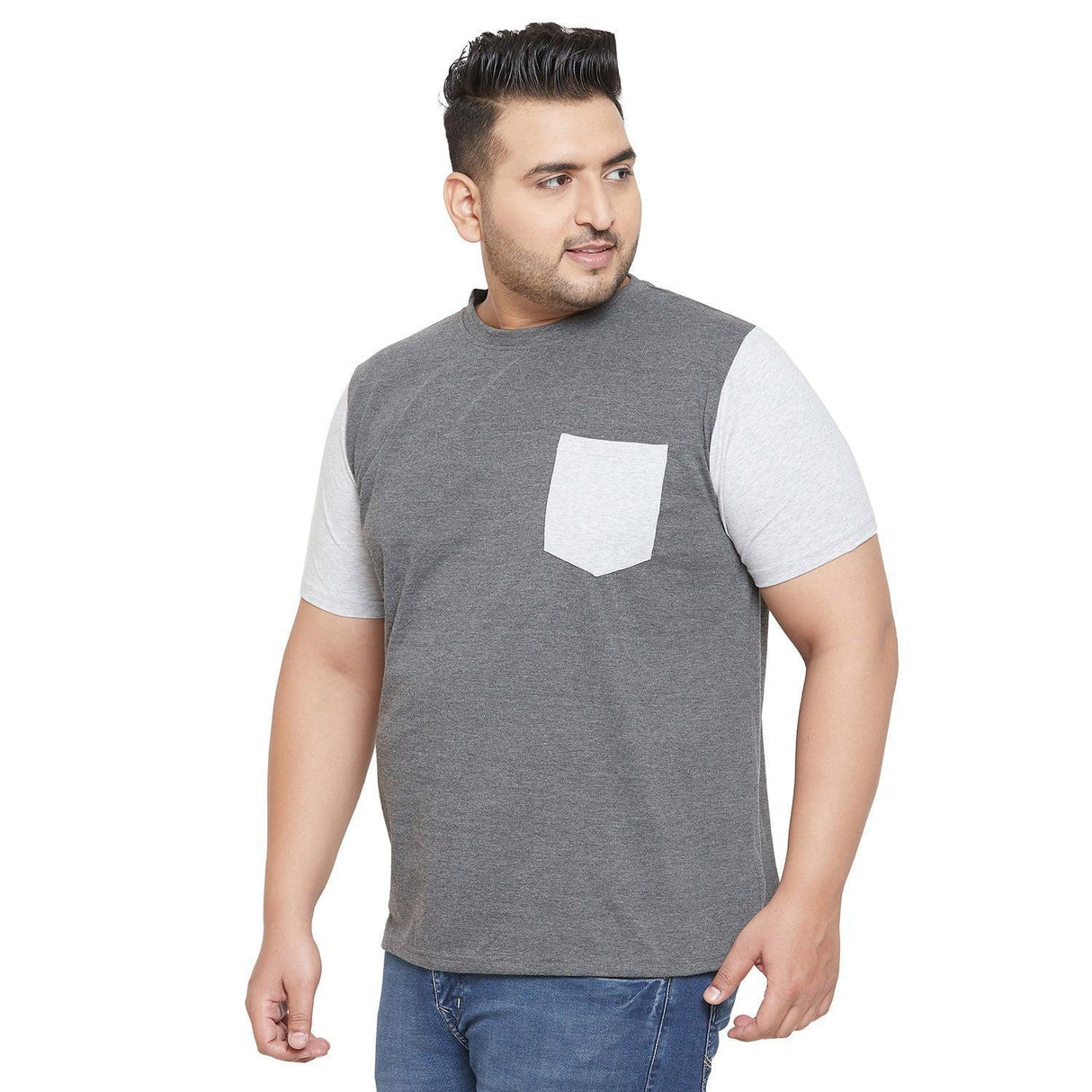 Plus size man in grey and light grey colorblock t-shirt with chest pocket and blue jeans