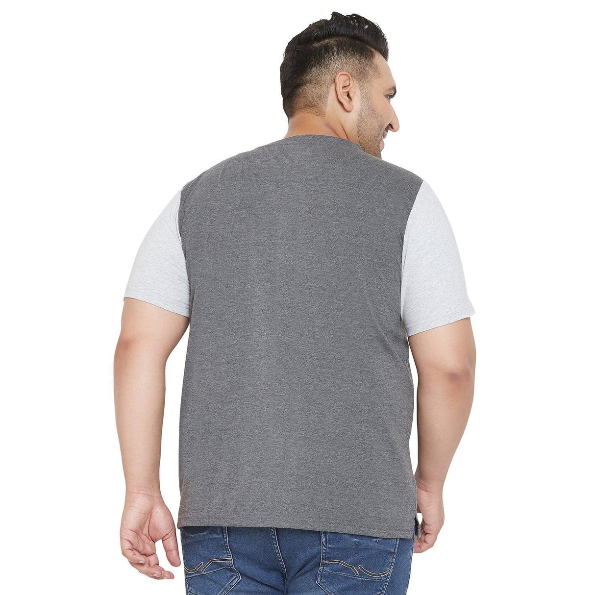Plus size man wearing a grey and light grey short sleeve t-shirt with blue jeans, back view