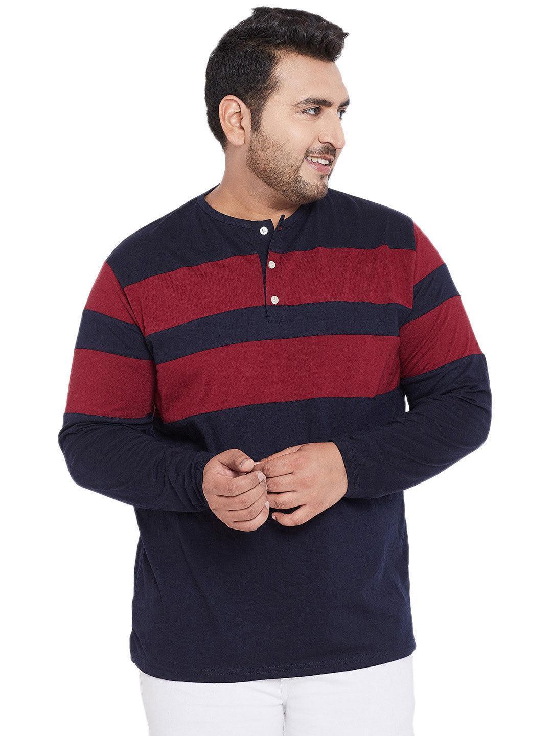 Plus size man wearing a navy and maroon striped long sleeve henley t-shirt