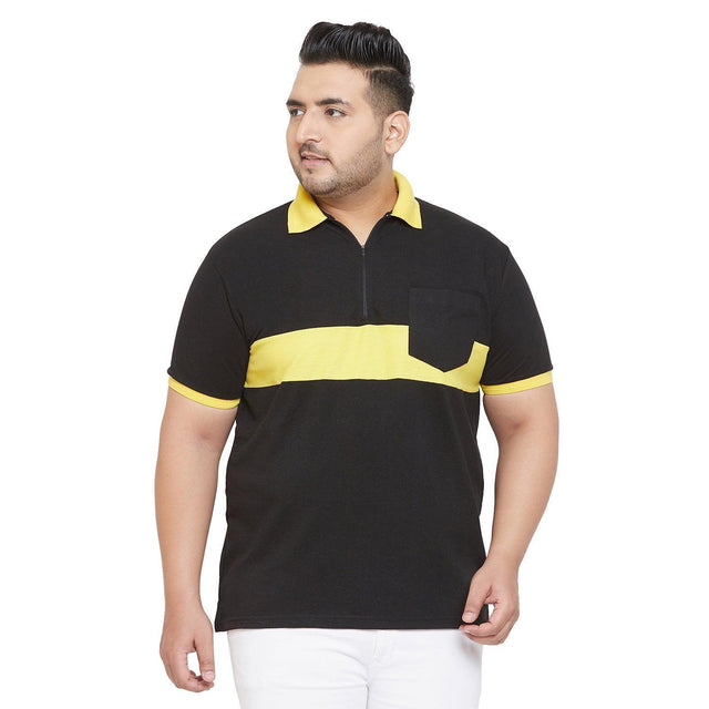 Plus size man in black and yellow colorblock polo t-shirt with front pocket, white pants