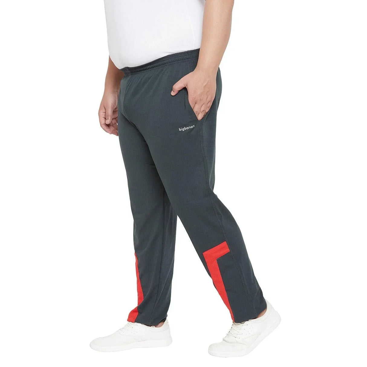 Plus size man in black joggers with red accents and white sneakers, side view