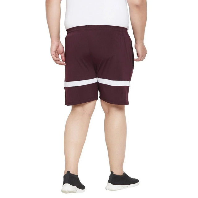 Back view of a man wearing maroon plus size shorts with white stripes and black sneakers