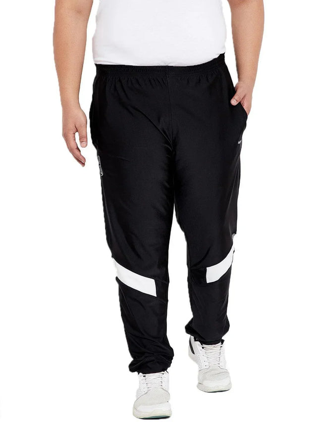 Plus size men's black joggers with white stripes, elastic waist, and white sneakers