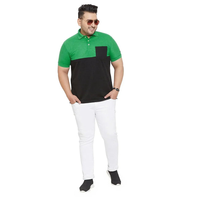 Plus size man wearing green and black colorblock polo shirt with white pants and sunglasses