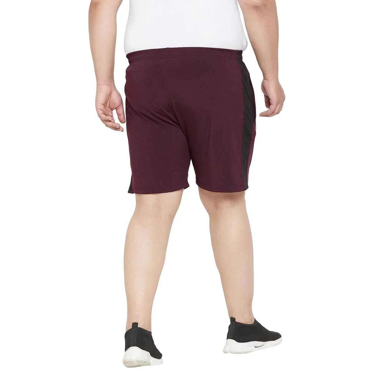 Back view of a man in plus size maroon athletic shorts with black side panels