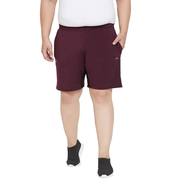 Plus size man wearing maroon shorts and white t-shirt, front view, casual fit.