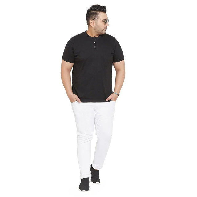 Plus size man wearing black henley t-shirt and white jeans, stylish casual outfit