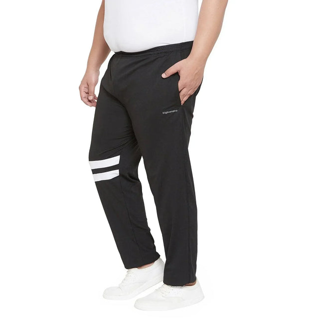 Men's plus size black joggers with white stripes, elastic waist, side pocket and white sneakers