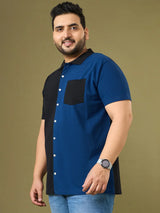 Plus size man in blue and black colorblock short sleeve shirt with black collar and pocket