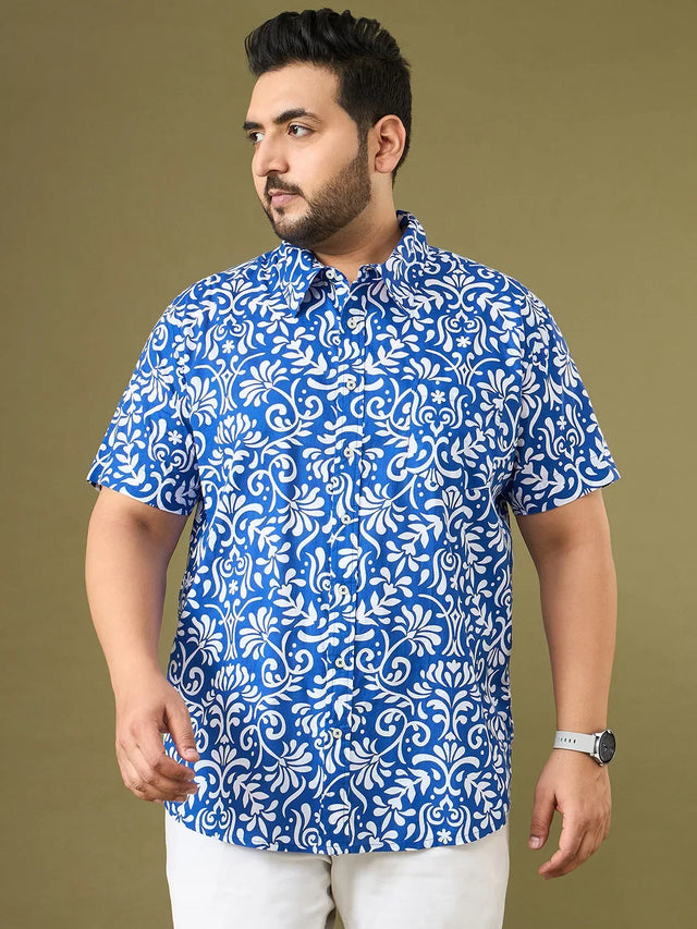 Man in plus size blue and white floral short sleeve shirt, summer fashion, beige background